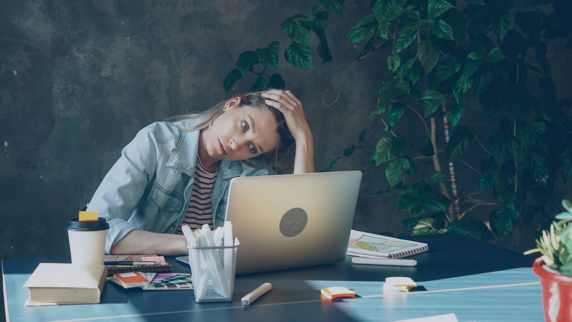 Business owner looking tired while working through accounts on her computer
